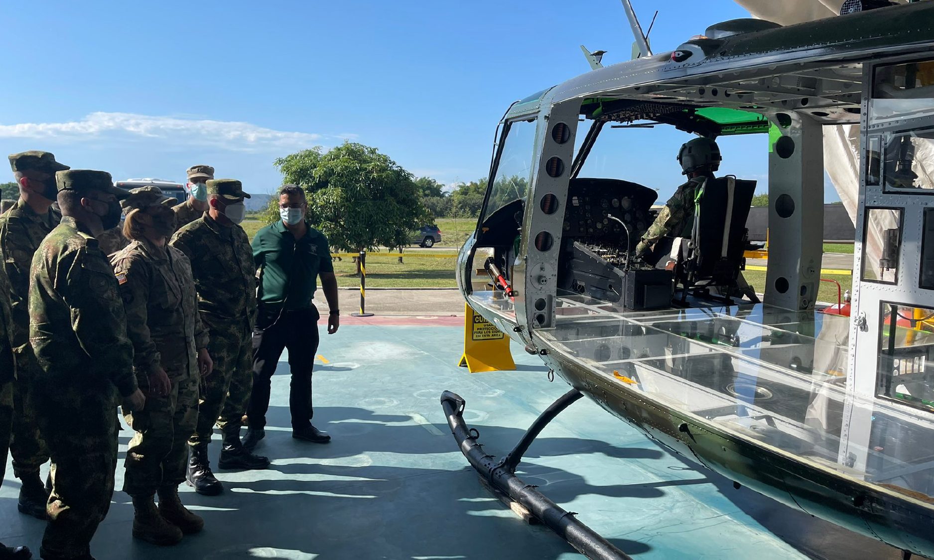 Military personnel viewing helicopter